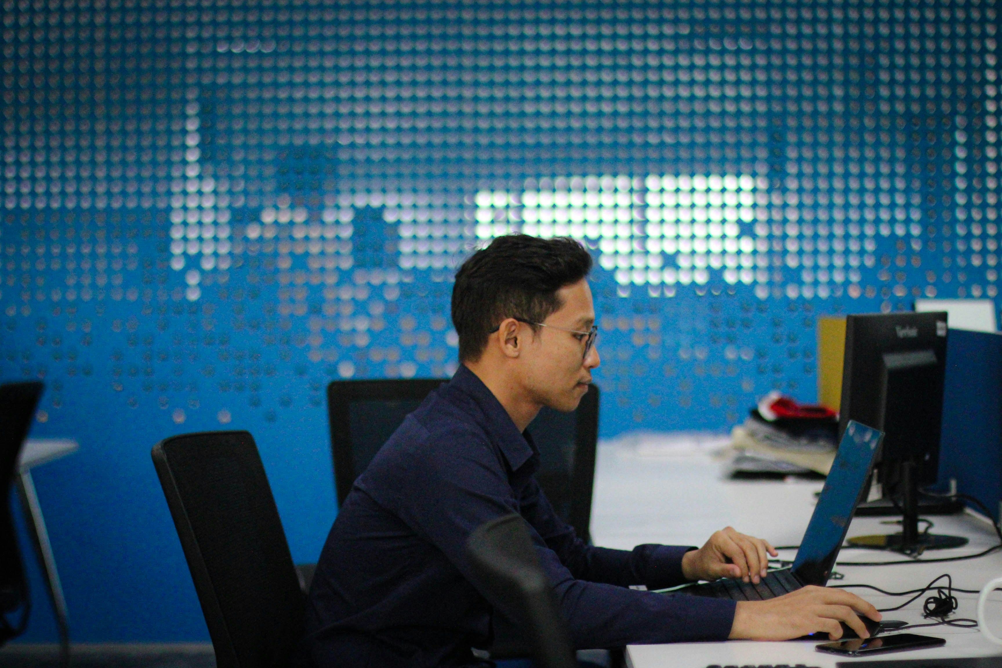 man using a laptop in an office