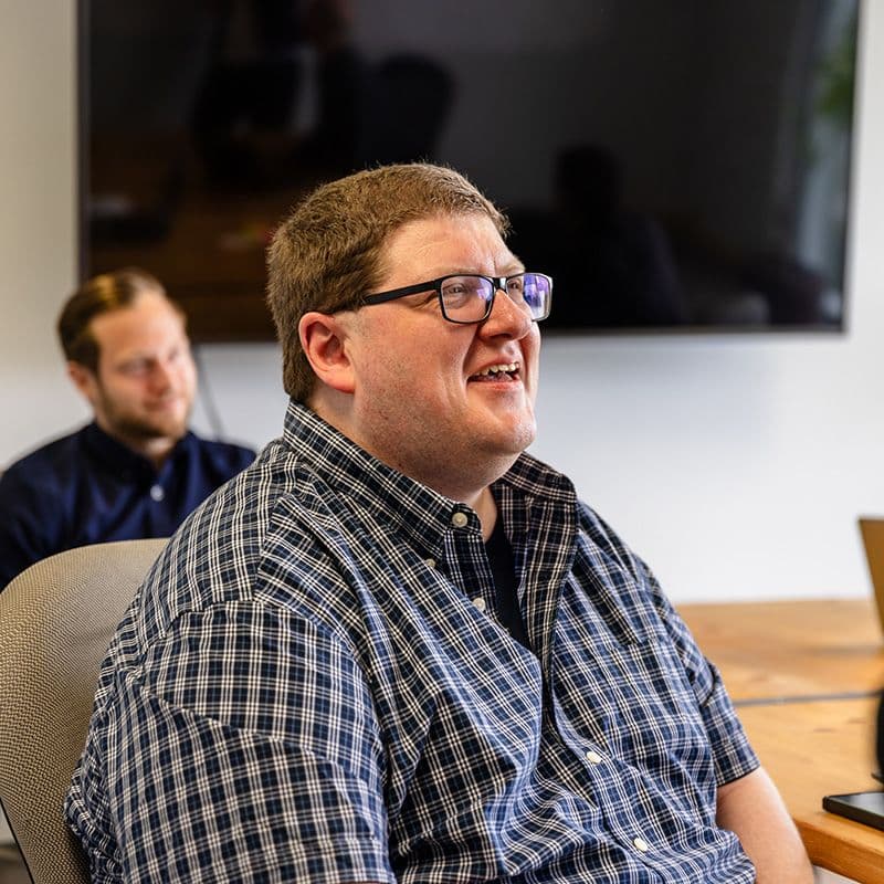 man smiling at a desk