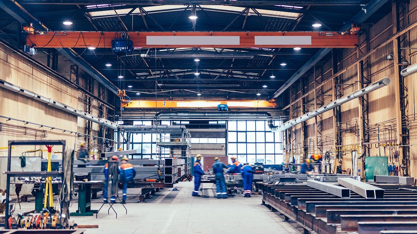 people working on an assembly line in a food factory